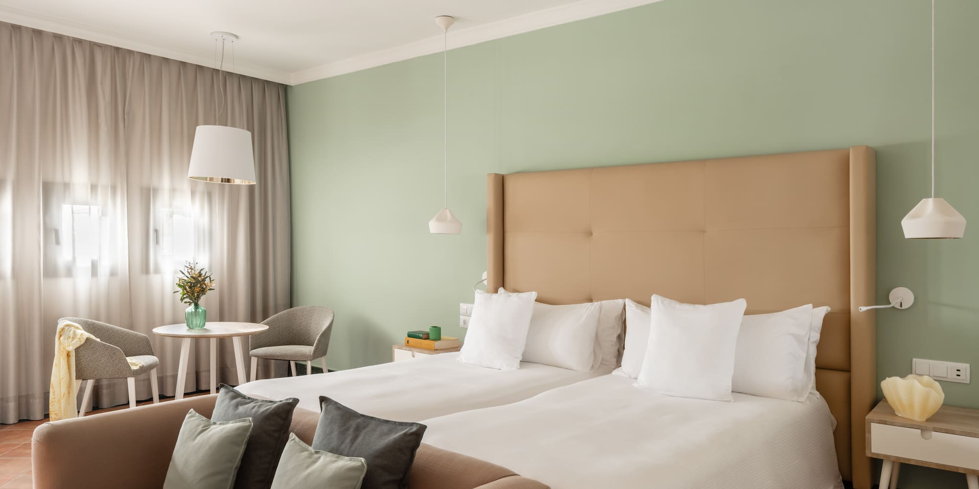 a room with two beds and a table