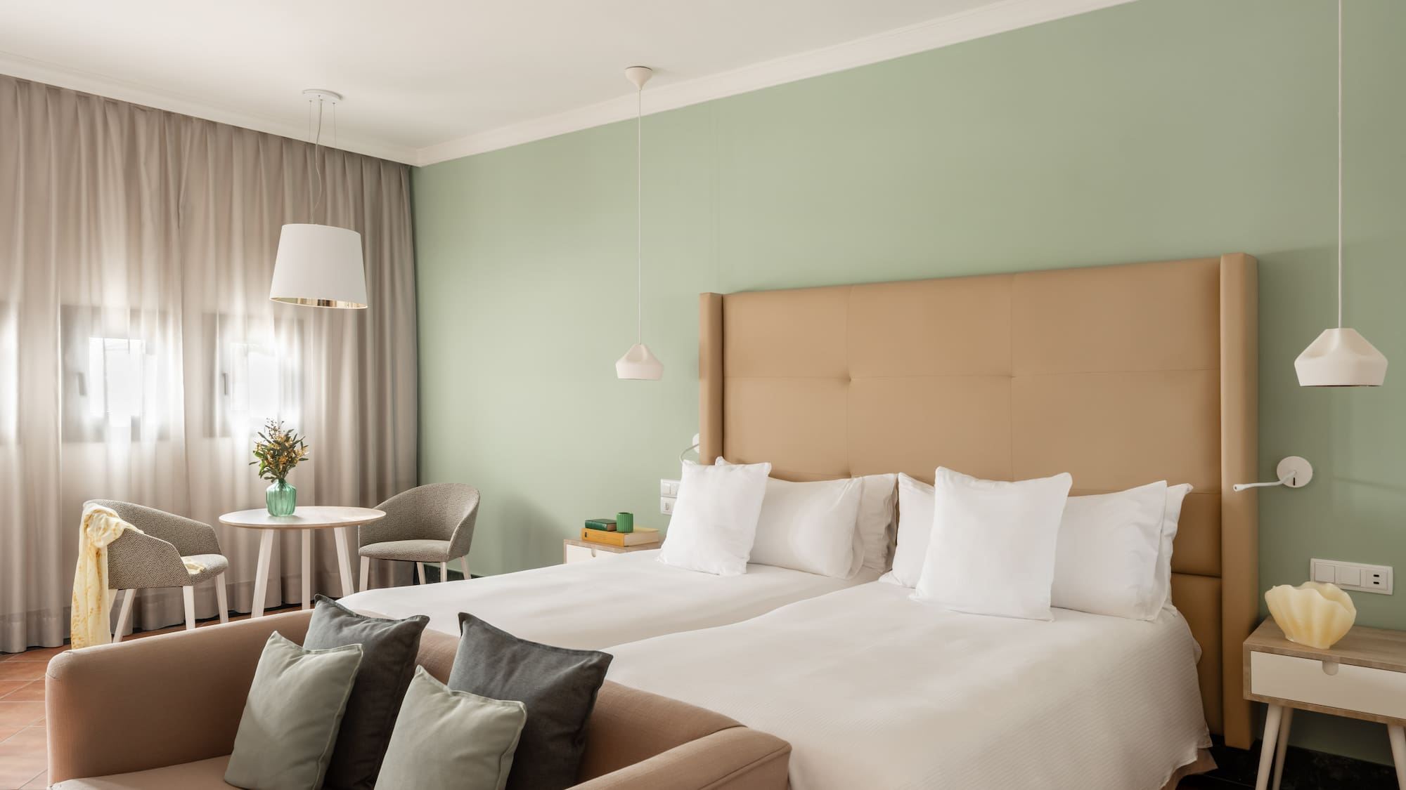 a room with two beds and a table