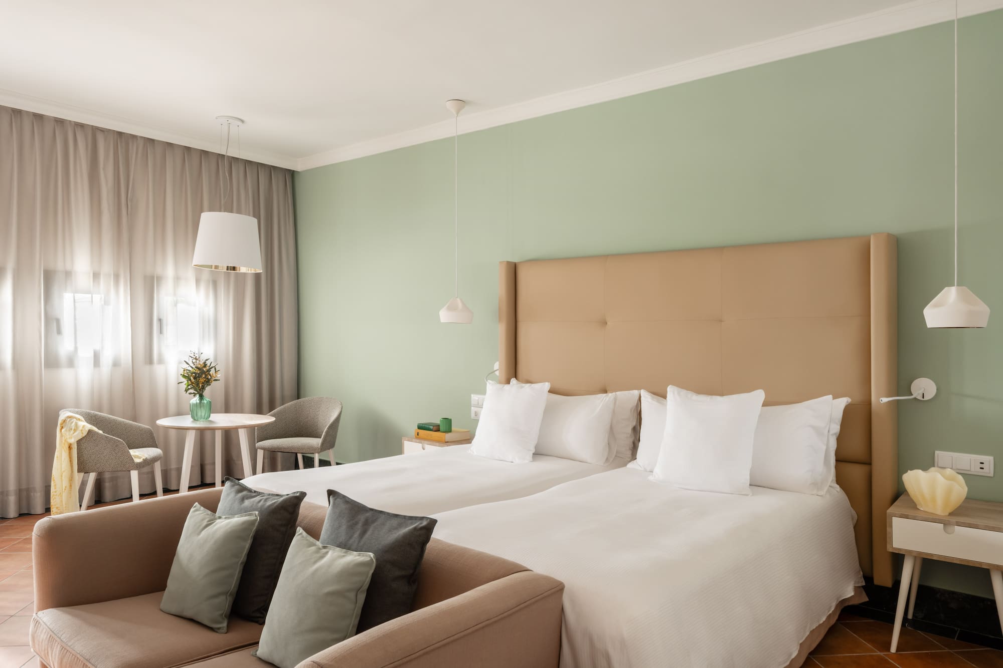 a room with two beds and a table