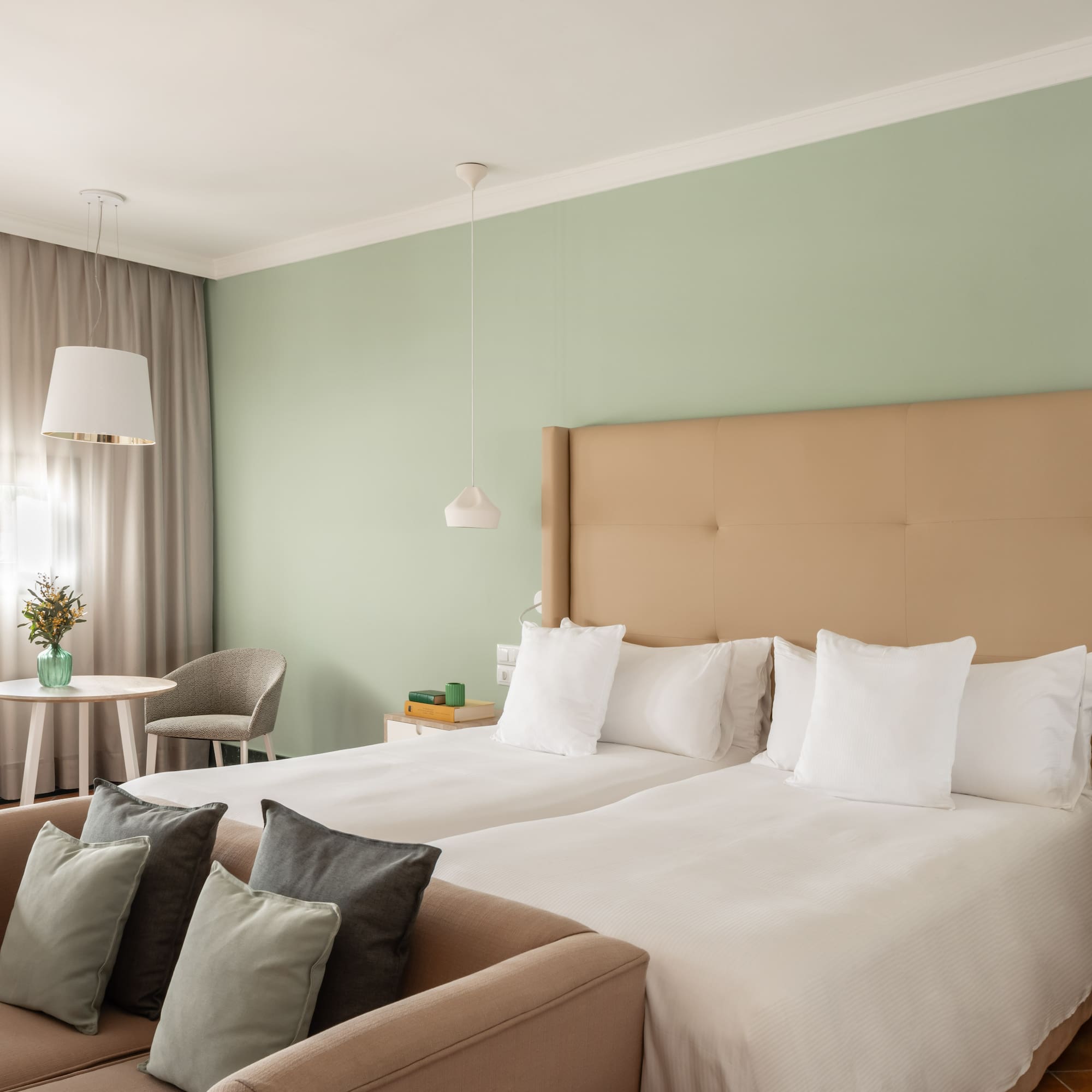 a room with two beds and a table