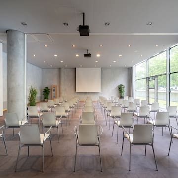 a room with many chairs and a projector screen