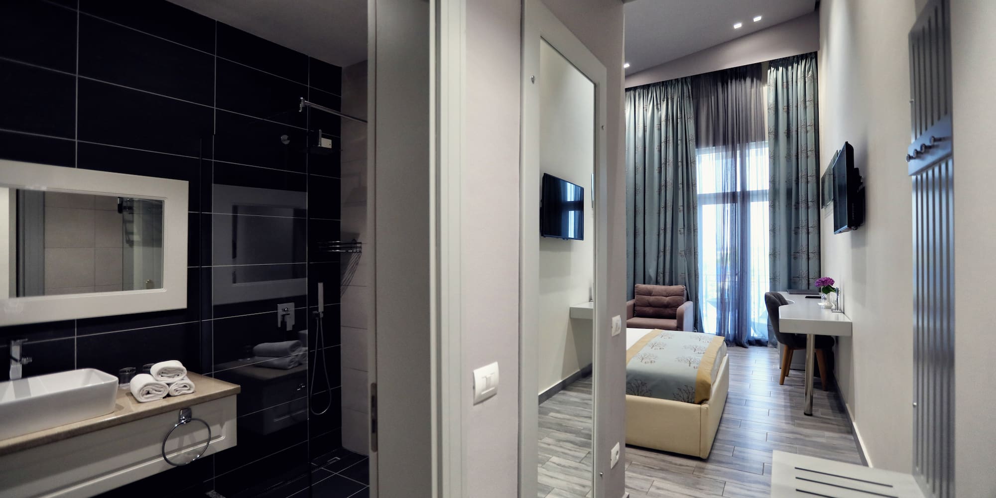 a room with a mirror and a bed