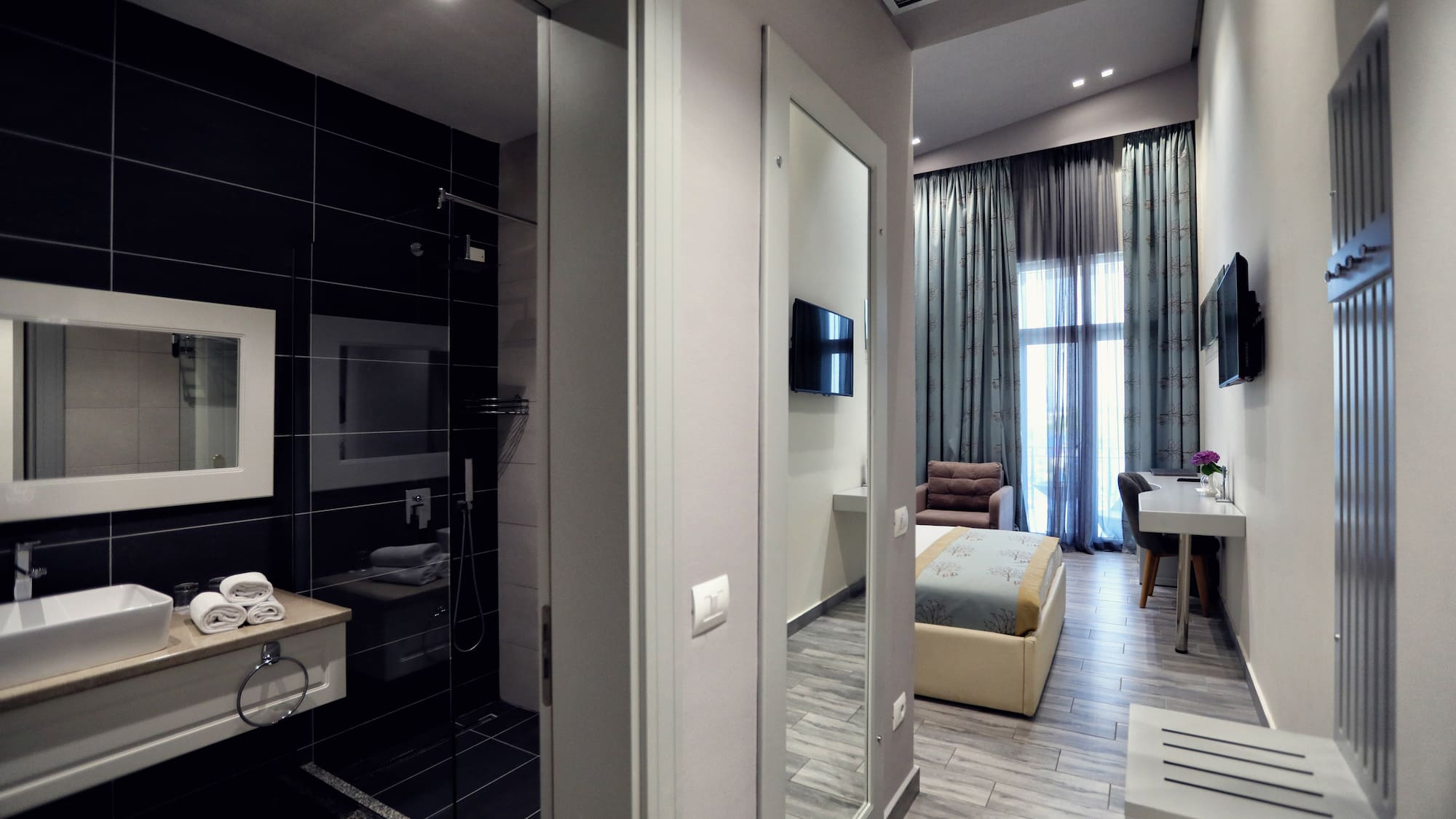 a room with a mirror and a bed