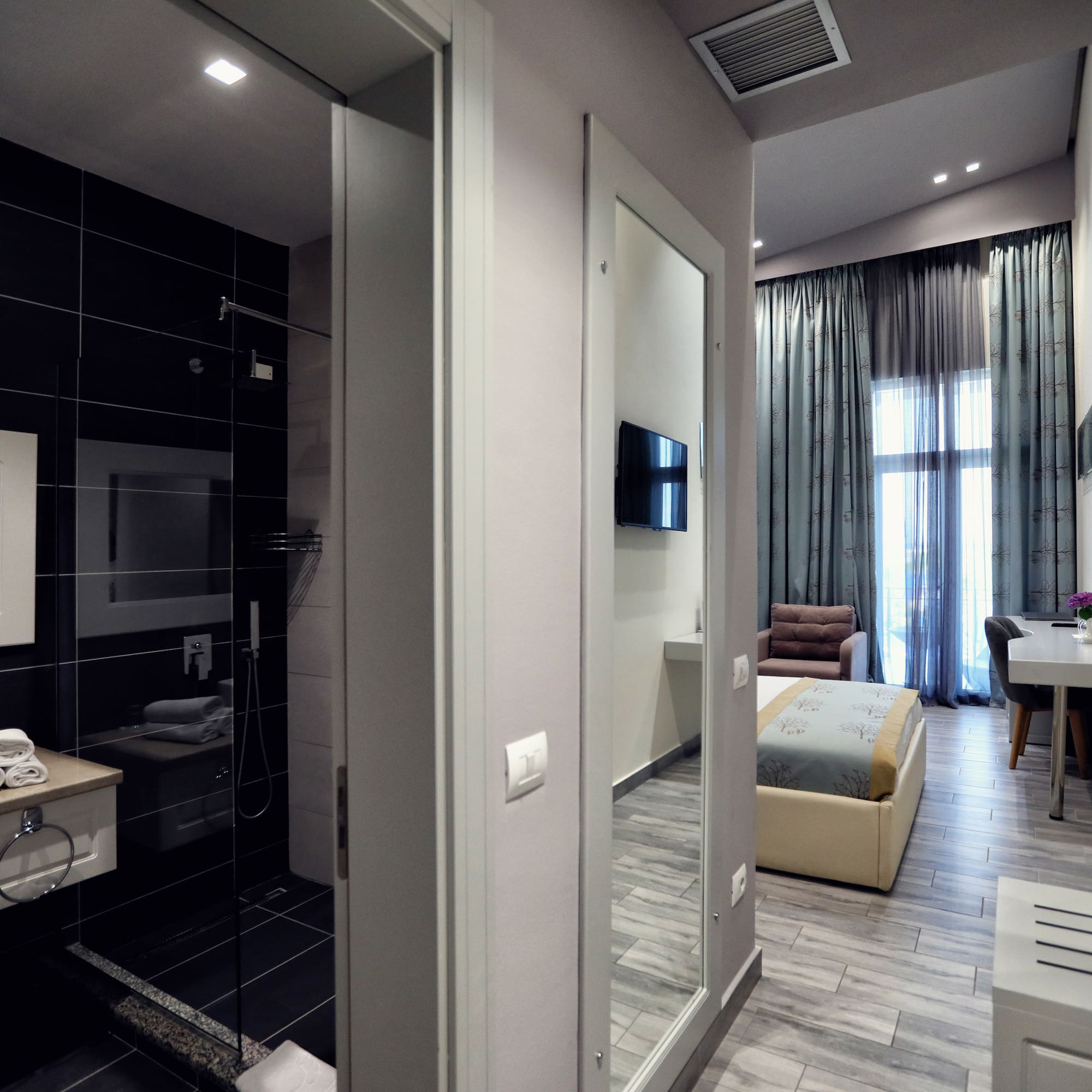 a room with a mirror and a bed