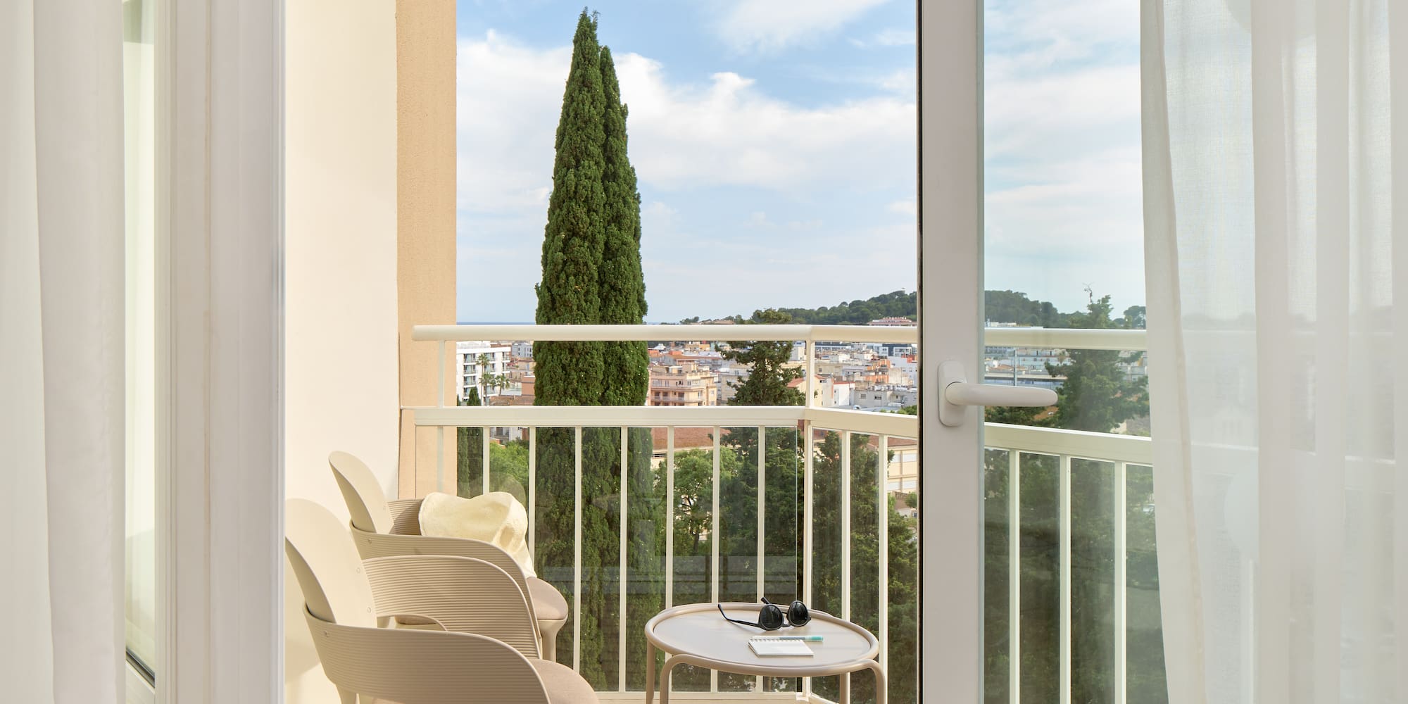 a balcony with chairs and a table