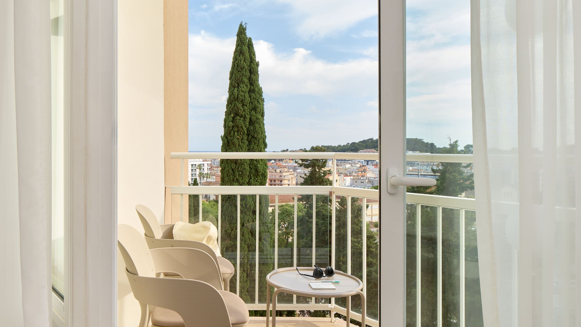 a balcony with chairs and a table