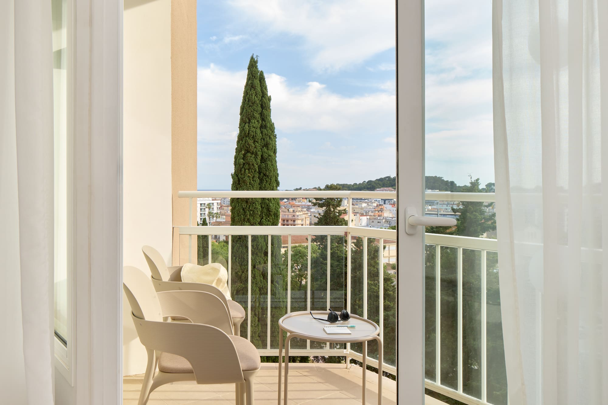 a balcony with chairs and a table