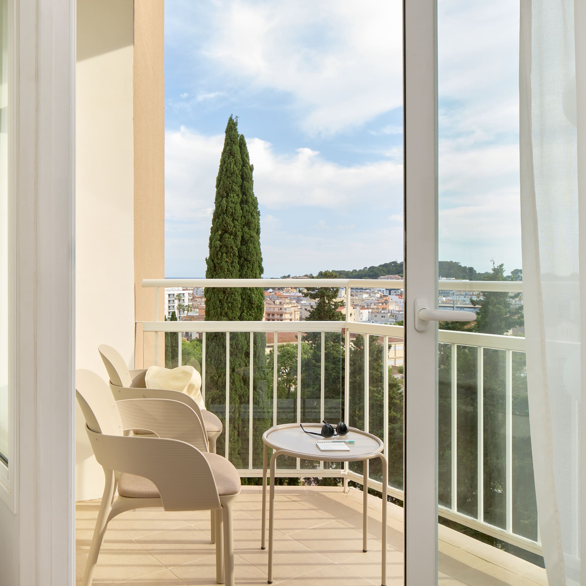 a balcony with chairs and a table