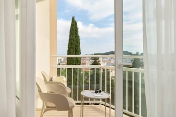 a balcony with chairs and a table.