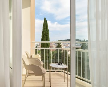 a balcony with chairs and a table.