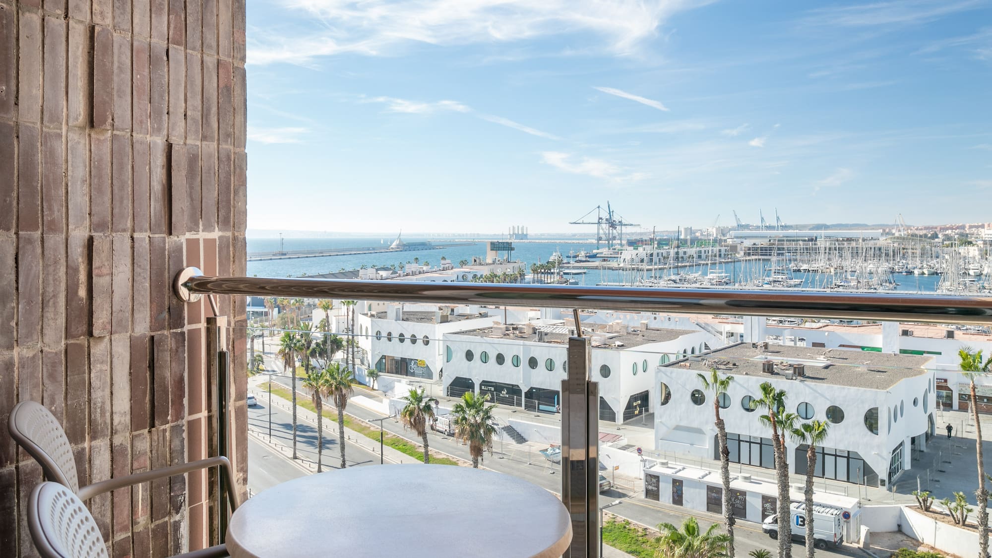 a table and railing on a balcony overlooking a city