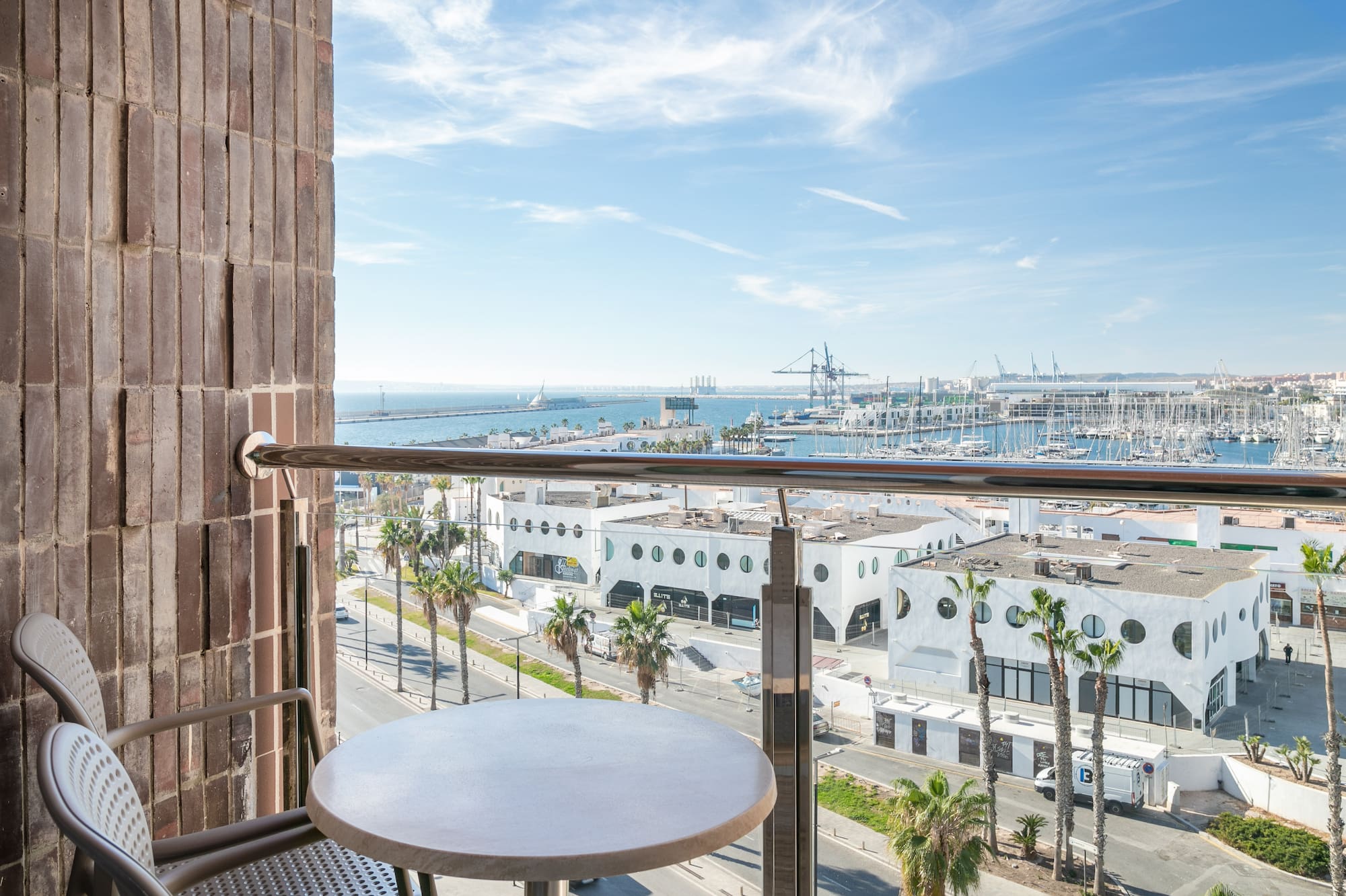 a table and railing on a balcony overlooking a city