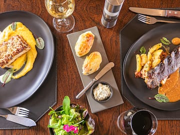 a table with plates of food and wine