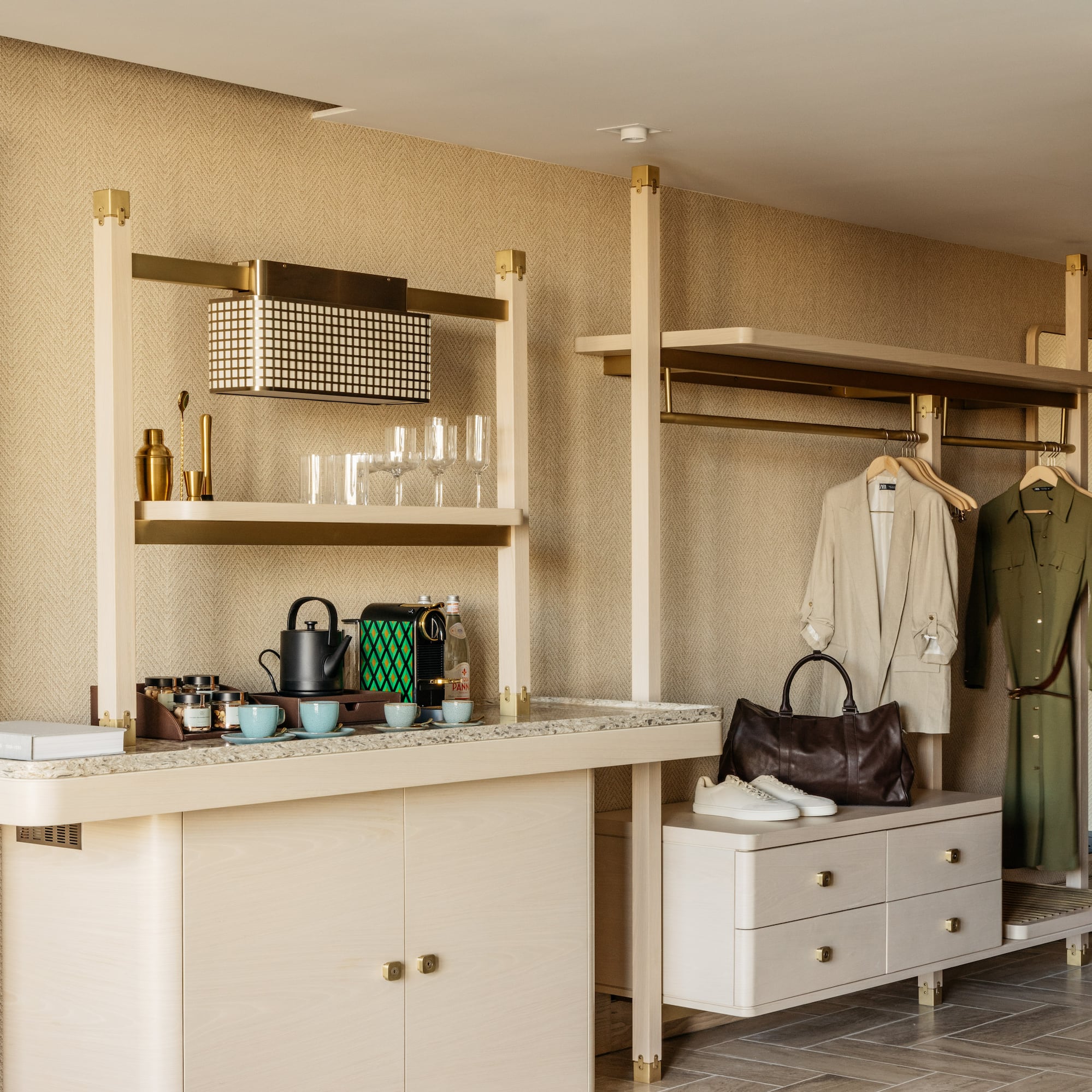 a room with a counter and shelves and a coat rack