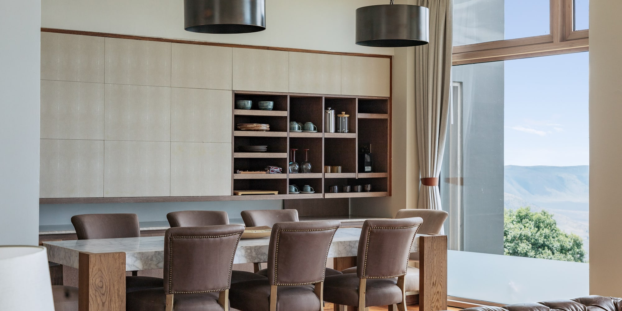 a dining room with a table and chairs