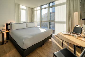 a bedroom with a bed and a table