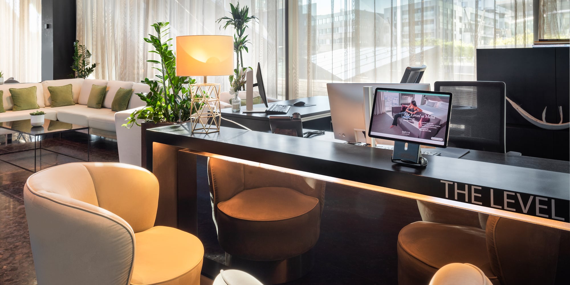 a room with a desk and chairs and a computer