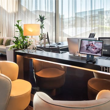 a room with a desk and chairs and a computer