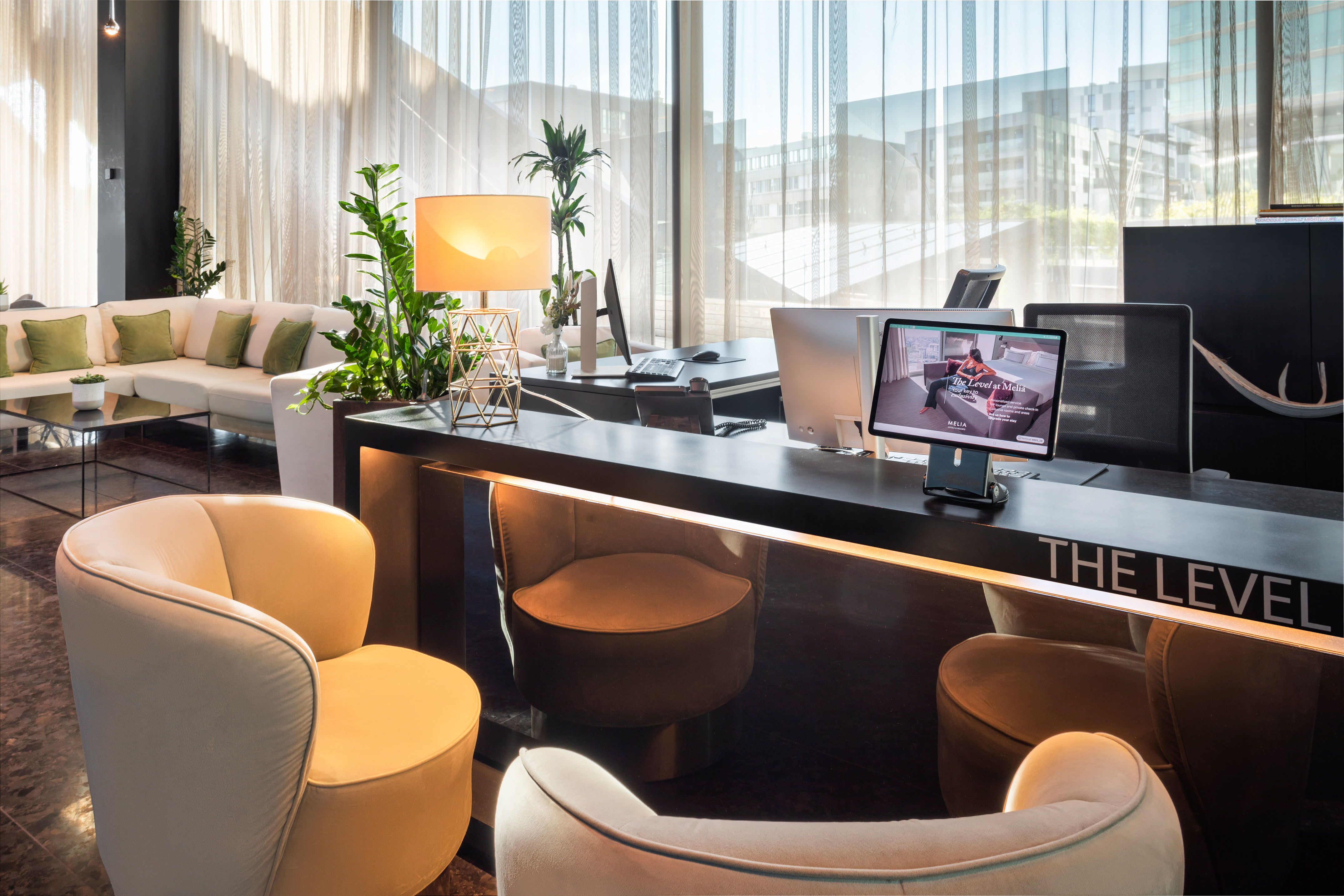 a room with a desk and chairs and a computer