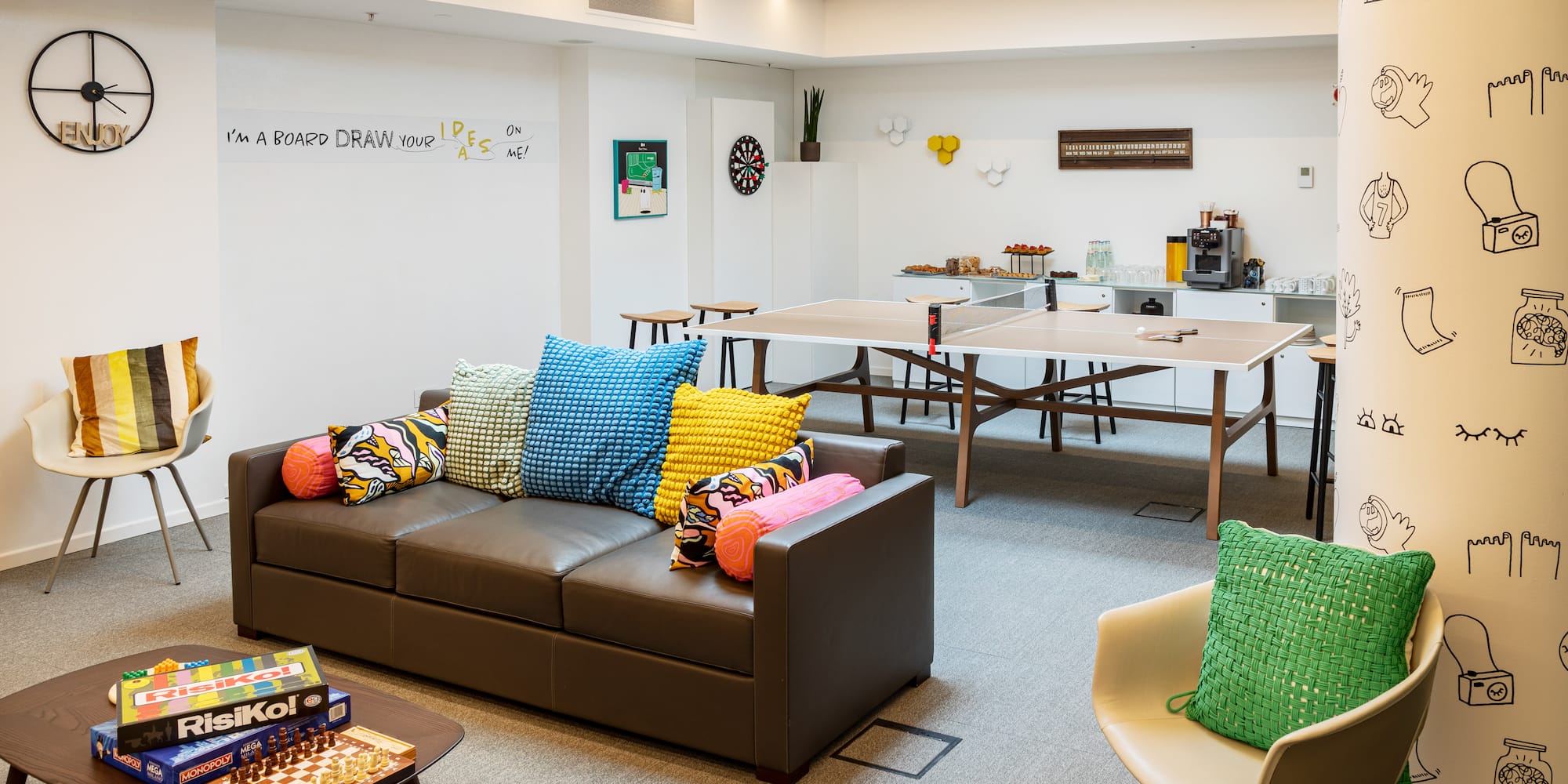 a room with a couch and table and chairs