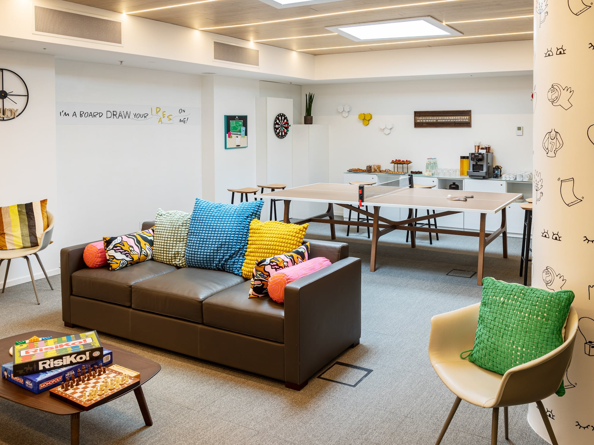 a room with a couch and table and chairs