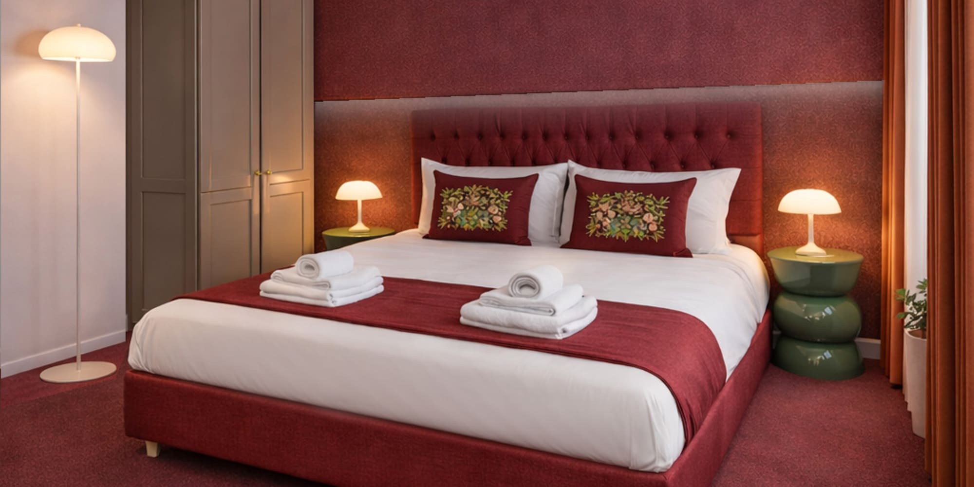 a bed with red carpet and lamps