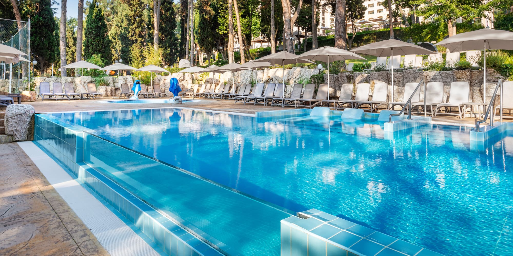 a pool with umbrellas and chairs