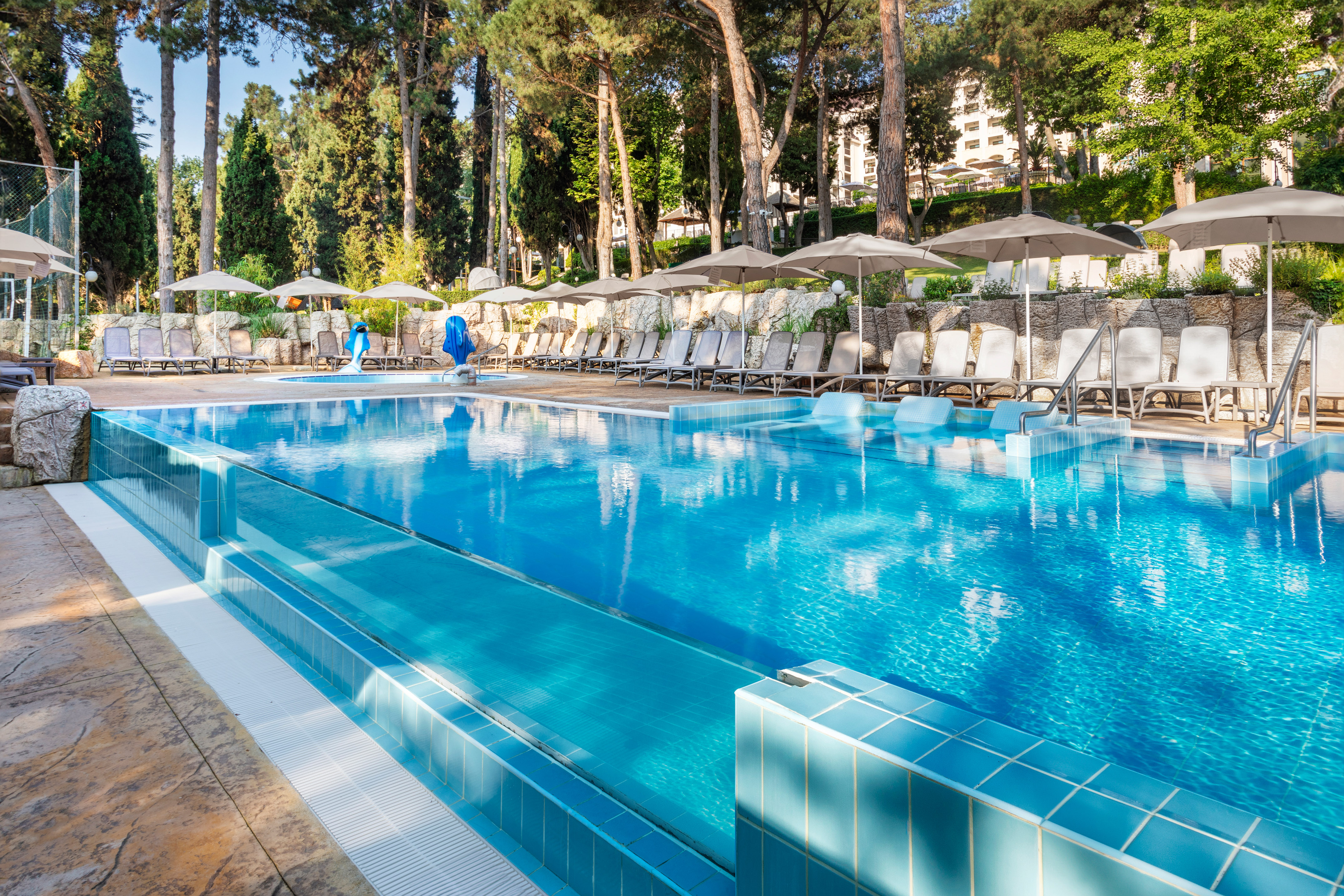 a pool with umbrellas and chairs