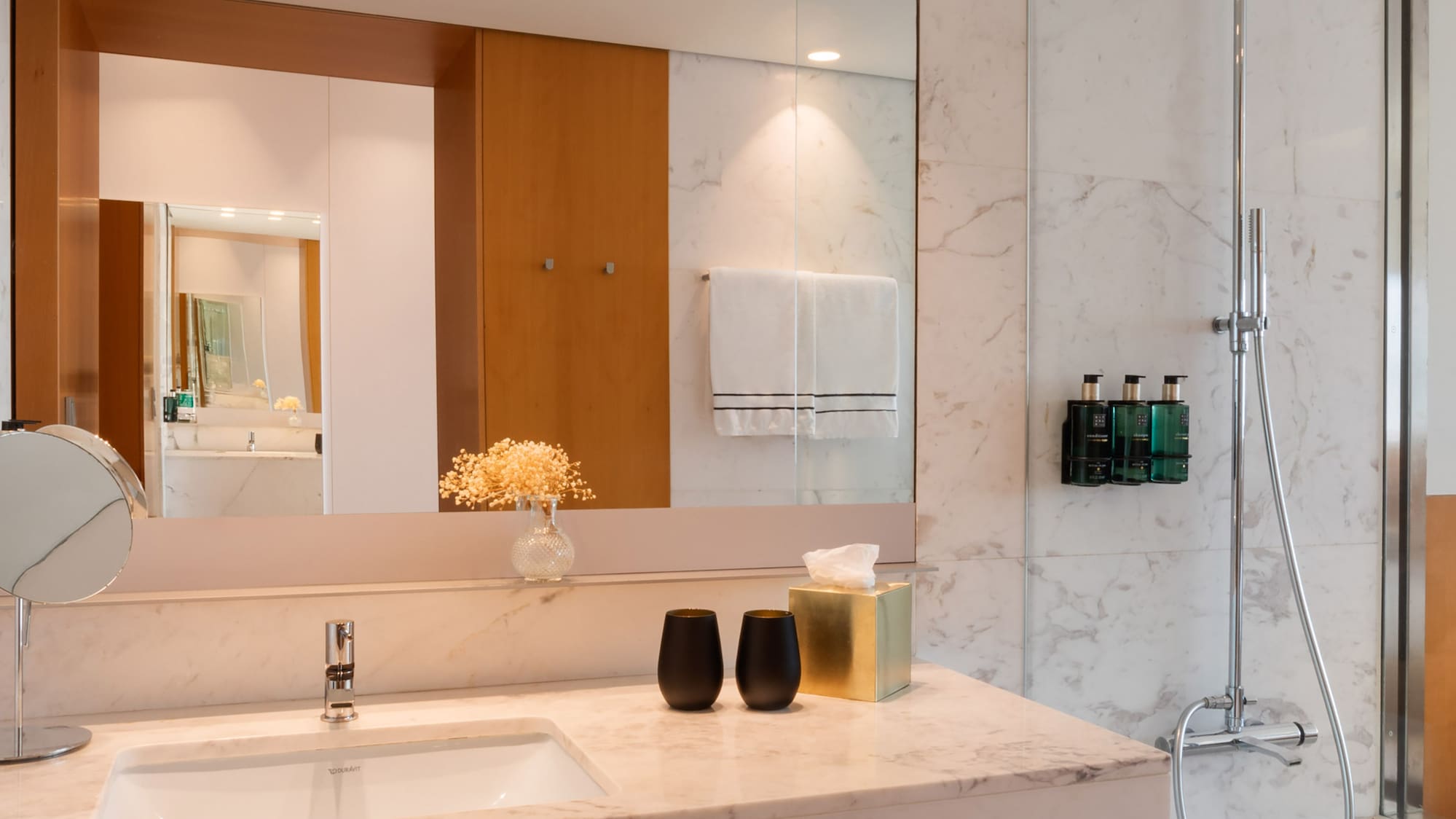 a bathroom with a marble countertop and shower