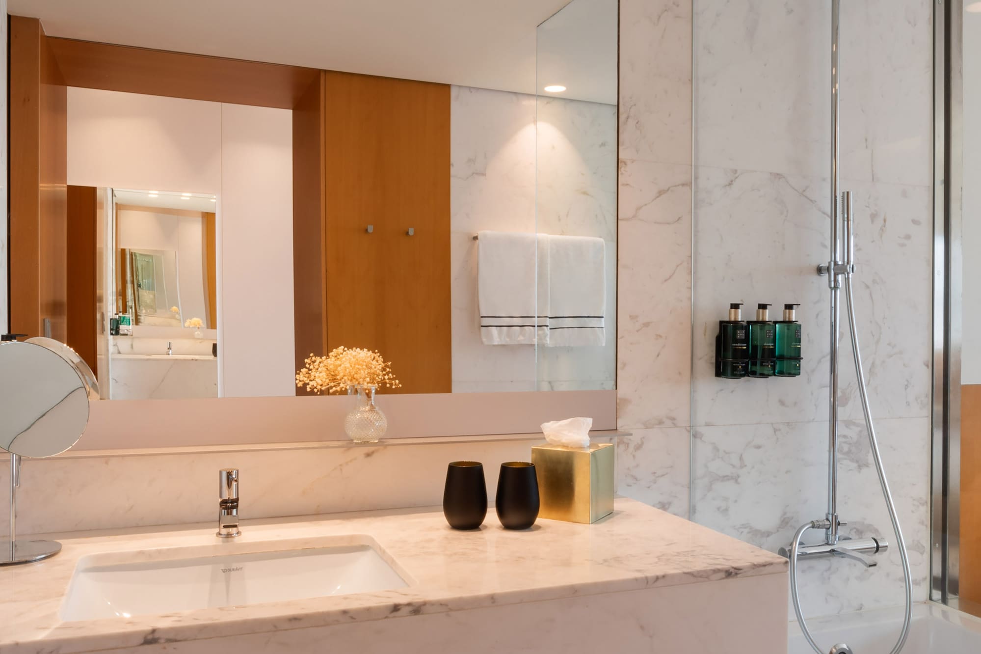 a bathroom with a marble countertop and shower