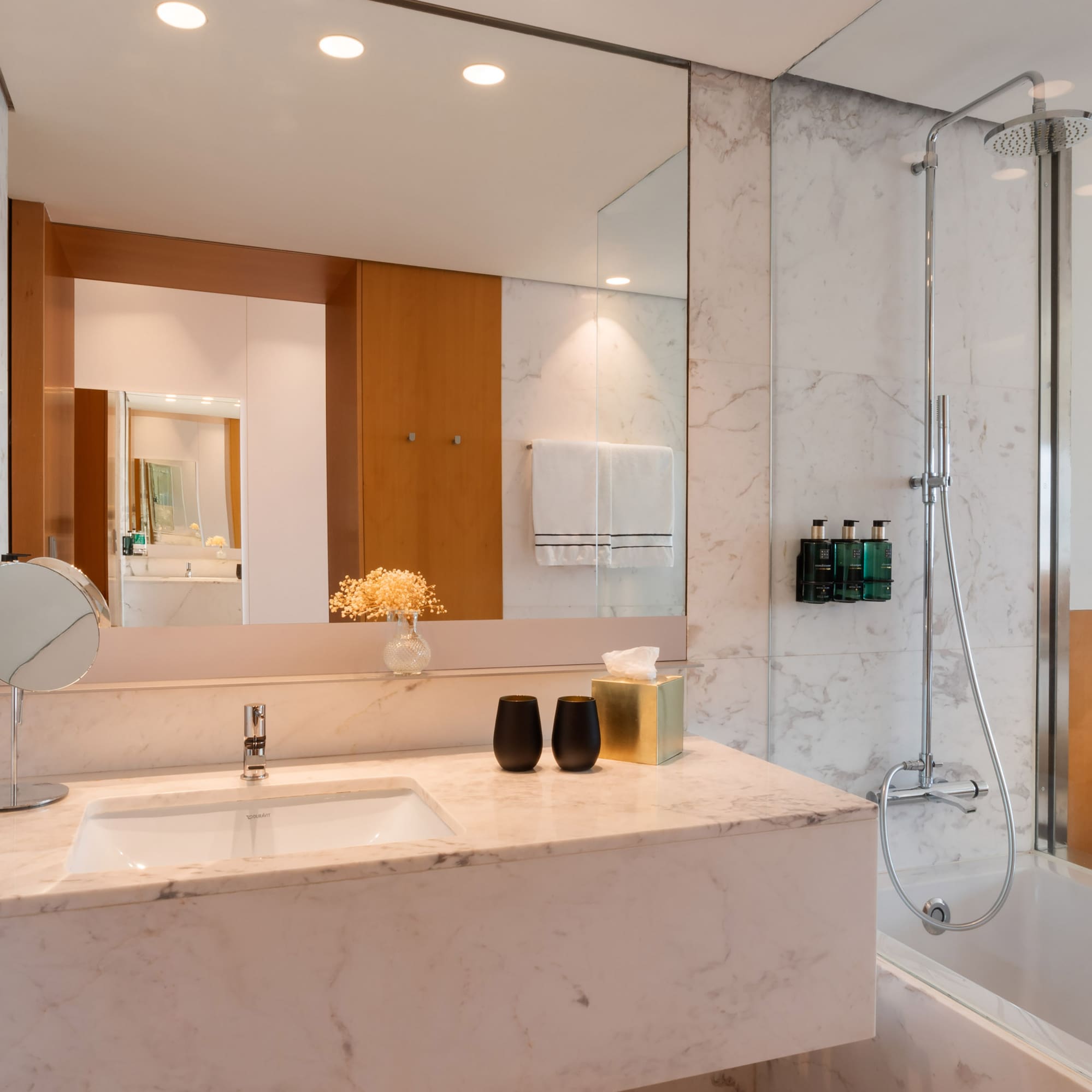 a bathroom with a marble countertop and shower