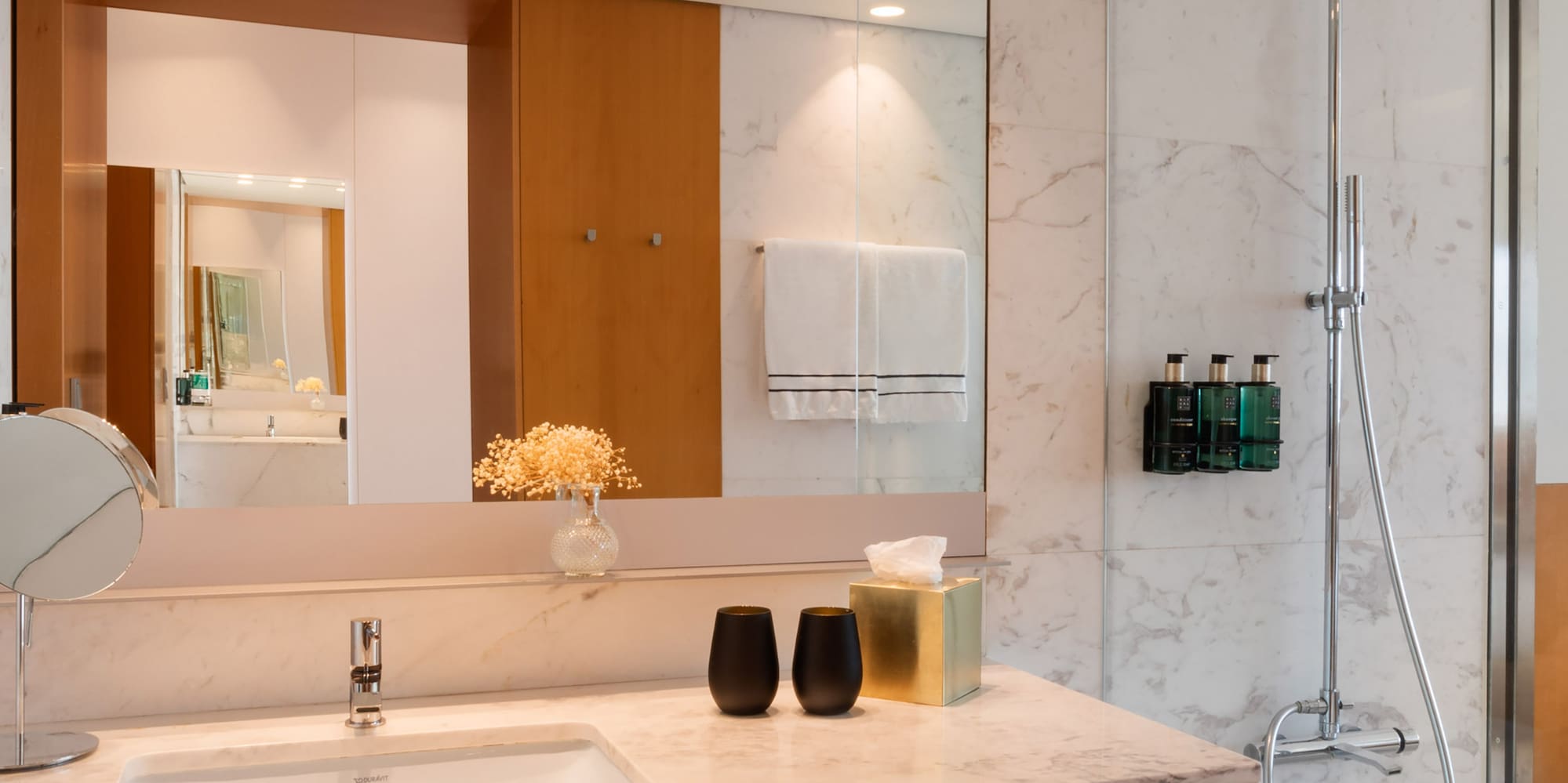 a bathroom with a marble countertop and shower