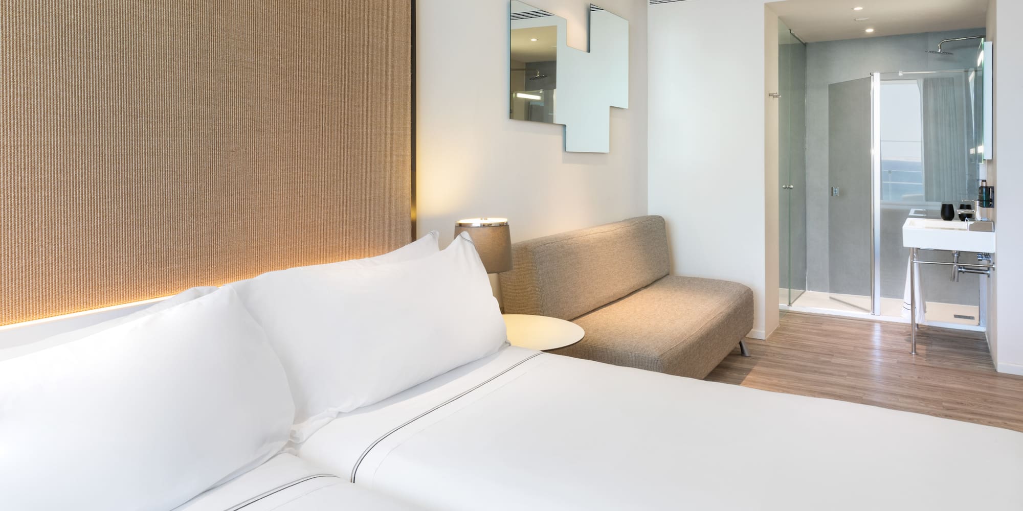 a room with two beds and a couch