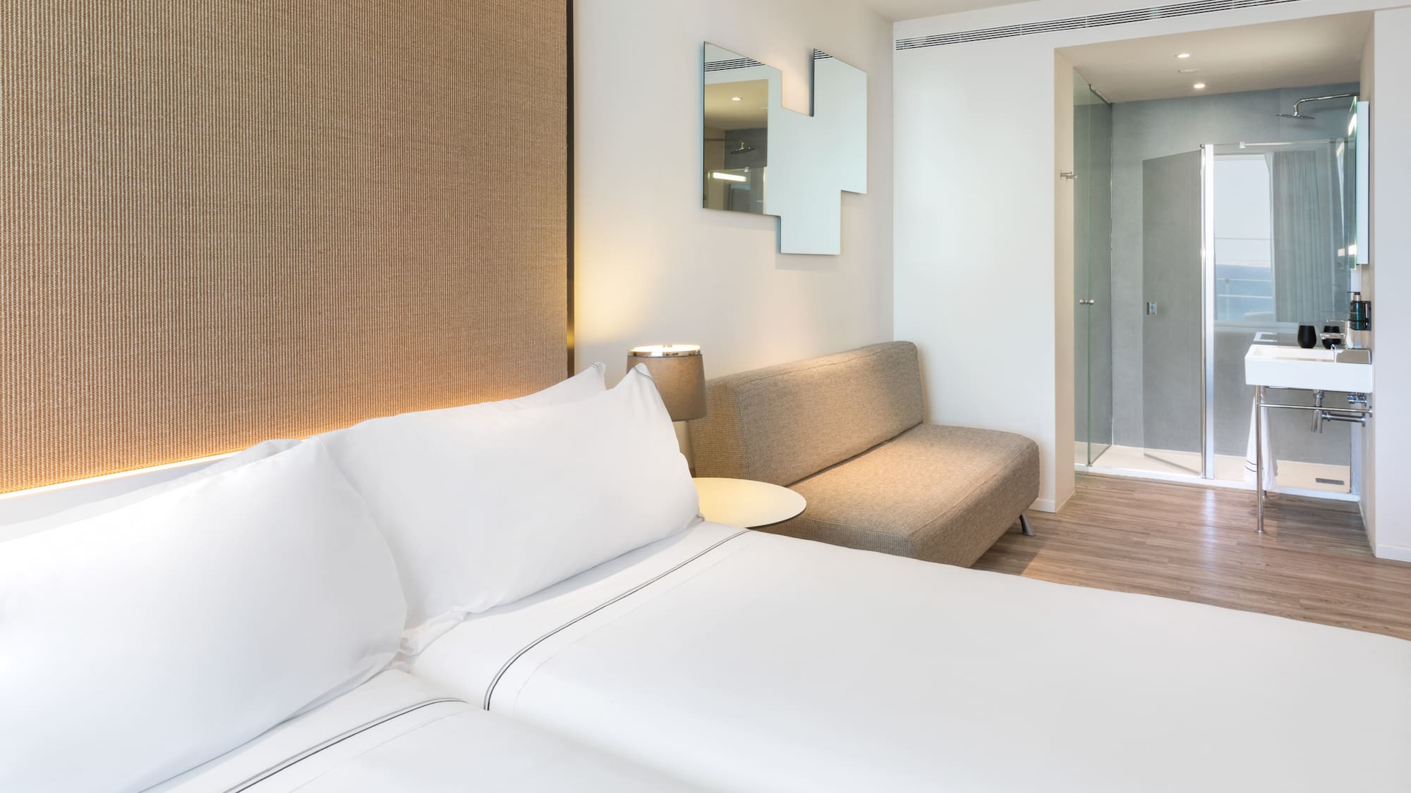 a room with two beds and a couch