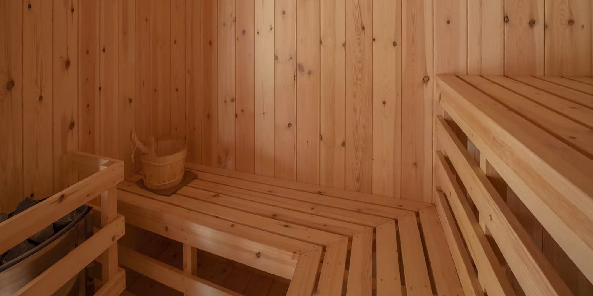 a wooden sauna with a bucket and a bucket