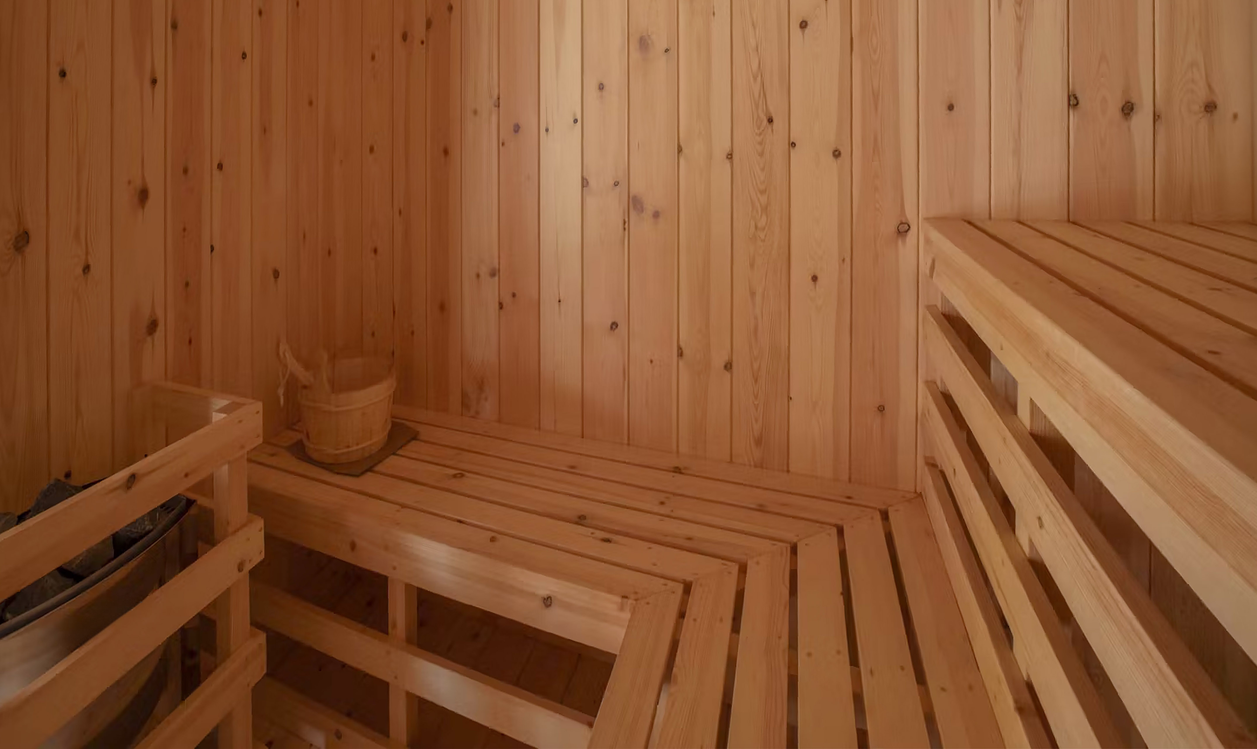 a wooden sauna with a bucket and a bucket