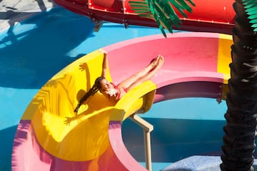 a girl in a swimsuit on a water slide