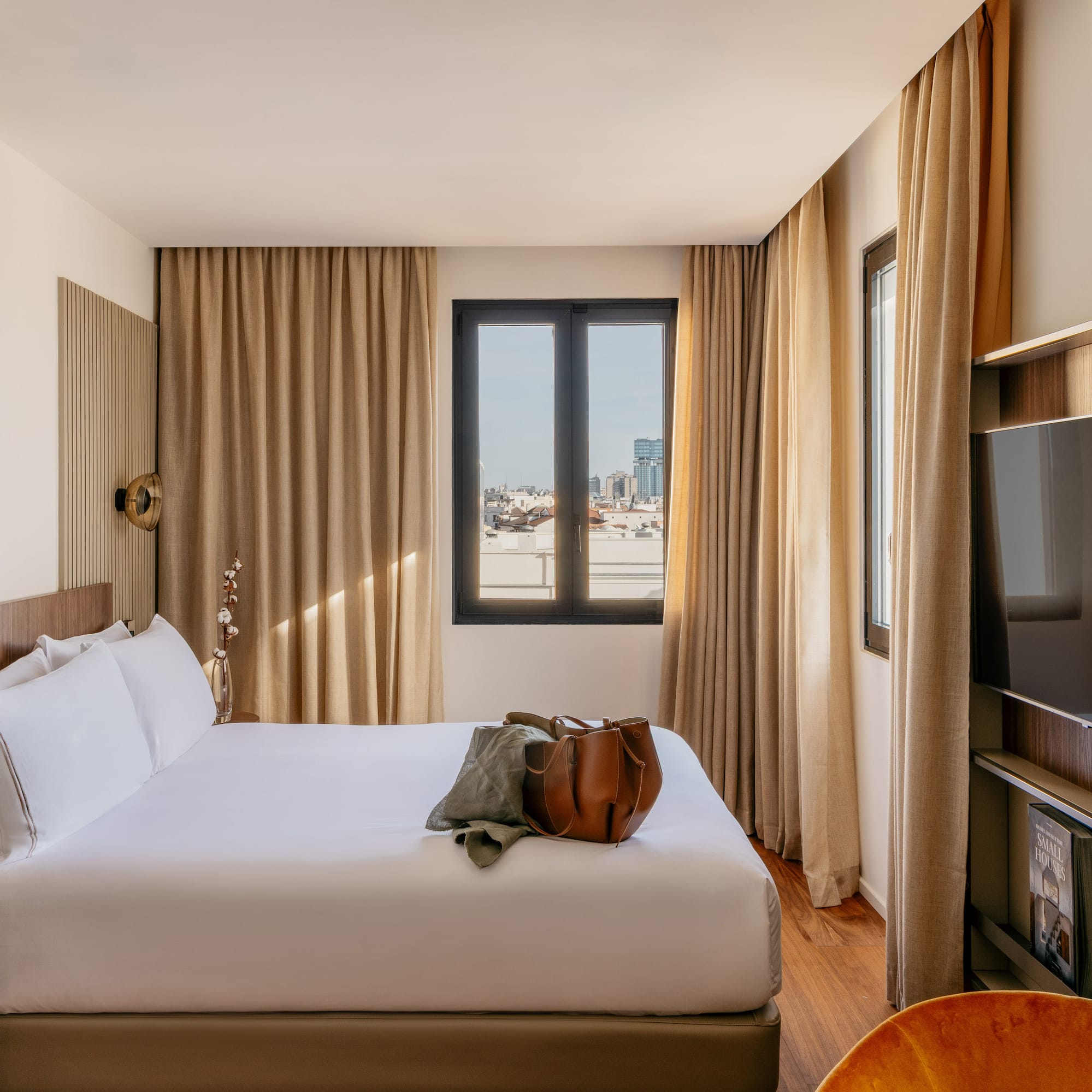 a room with a bed and a television