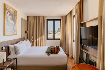 a room with a bed and a television