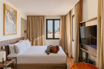 a room with a bed and a television