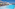 Hotel rooftop infinity pool with sun loungers, umbrellas, and sea view.
