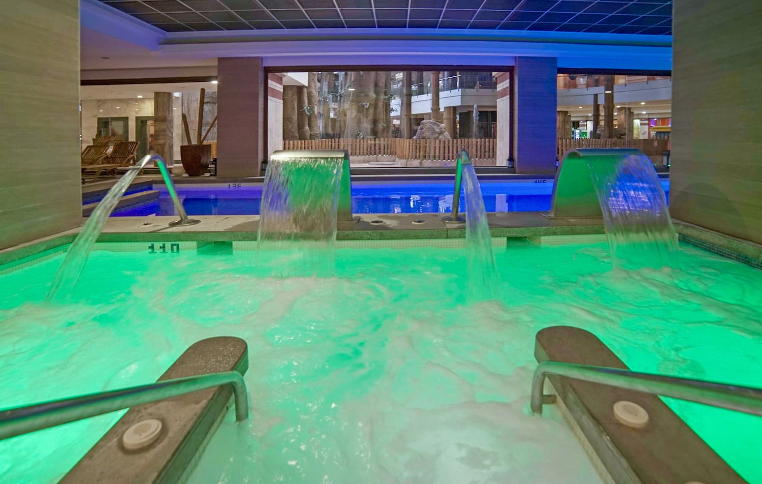 a pool with green lights