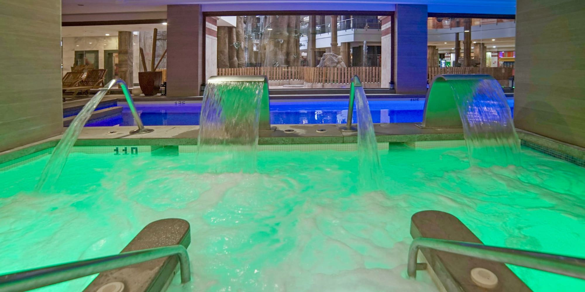 a pool with green lights