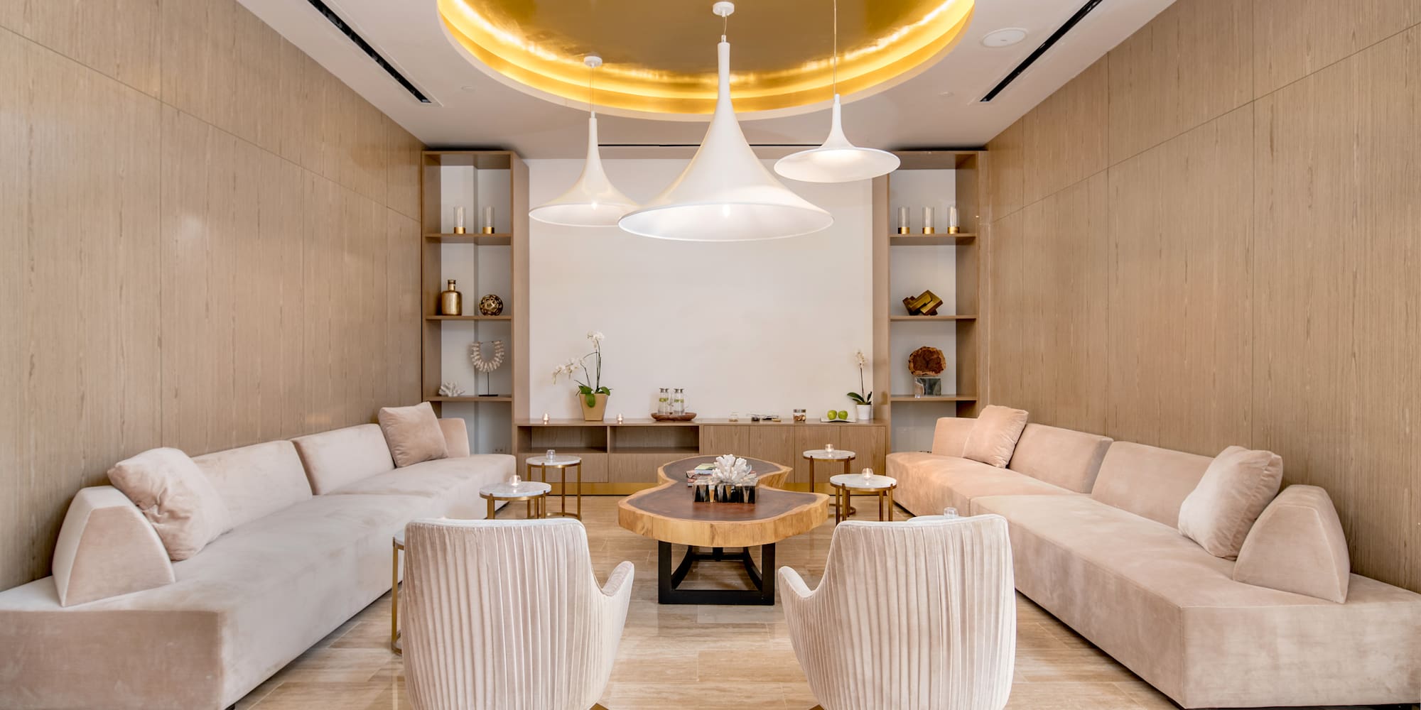 a room with a couch and chairs