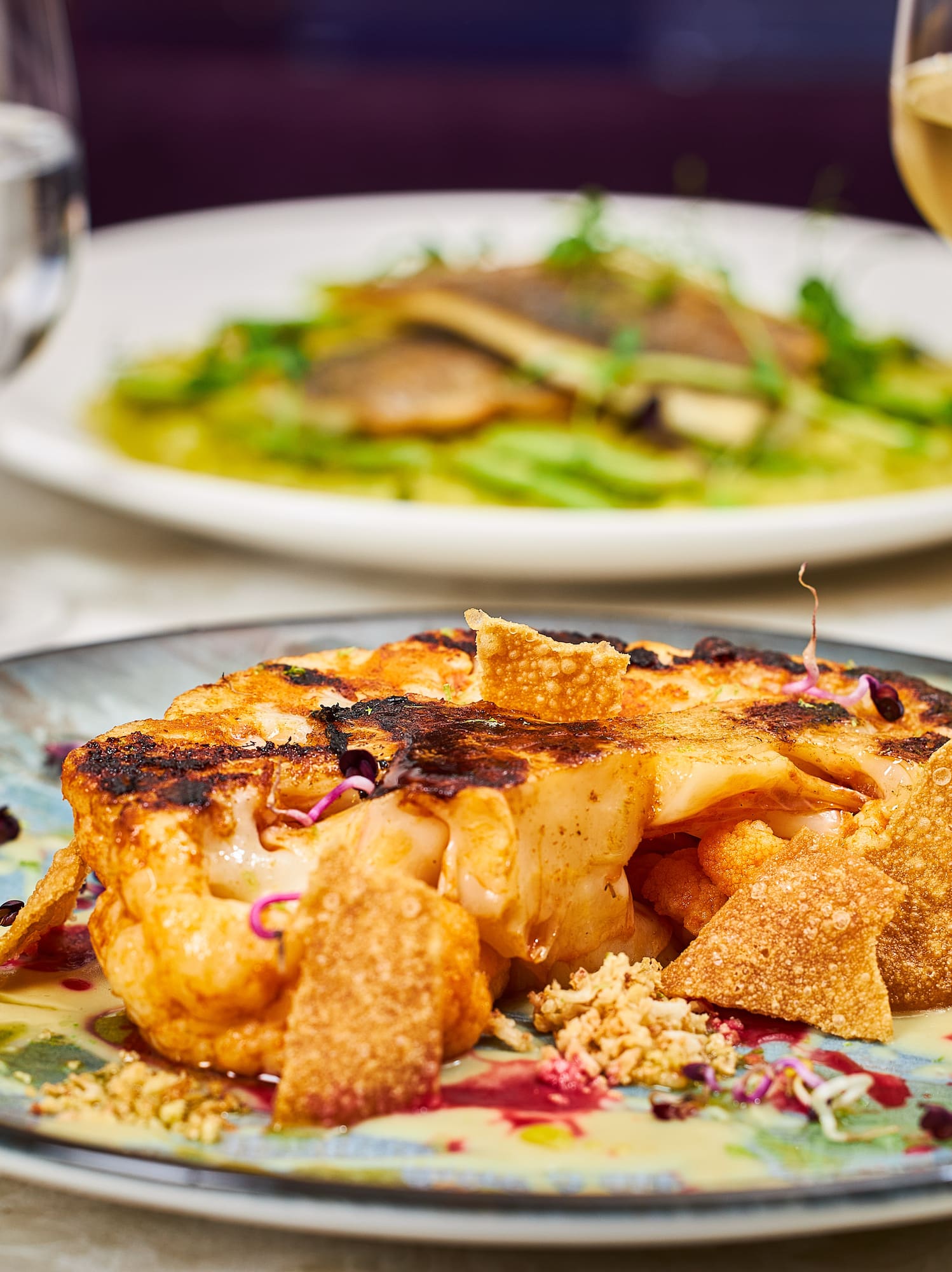 a plate of food and a glass of wine