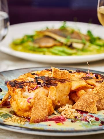 a plate of food and a glass of wine