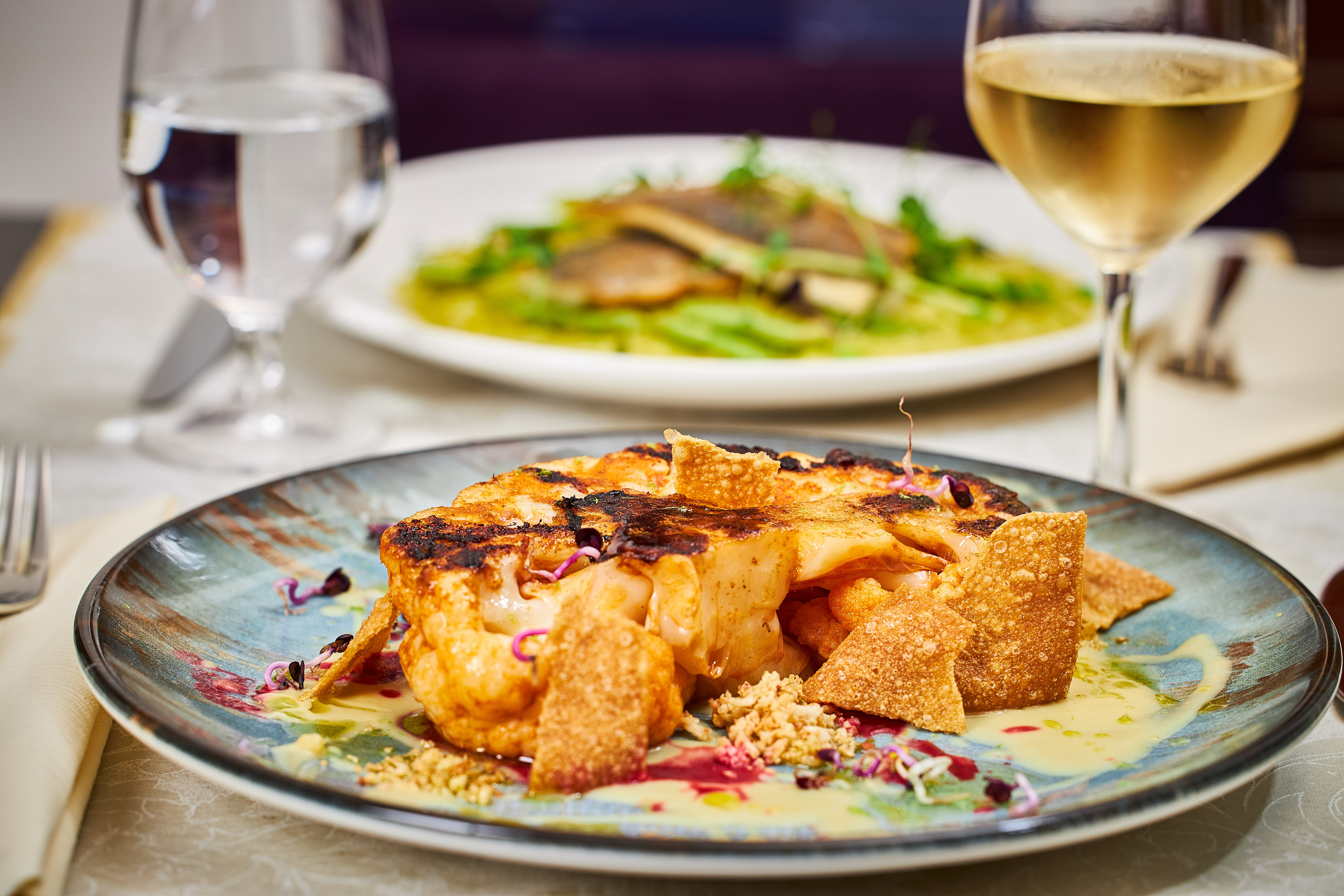 a plate of food and a glass of wine