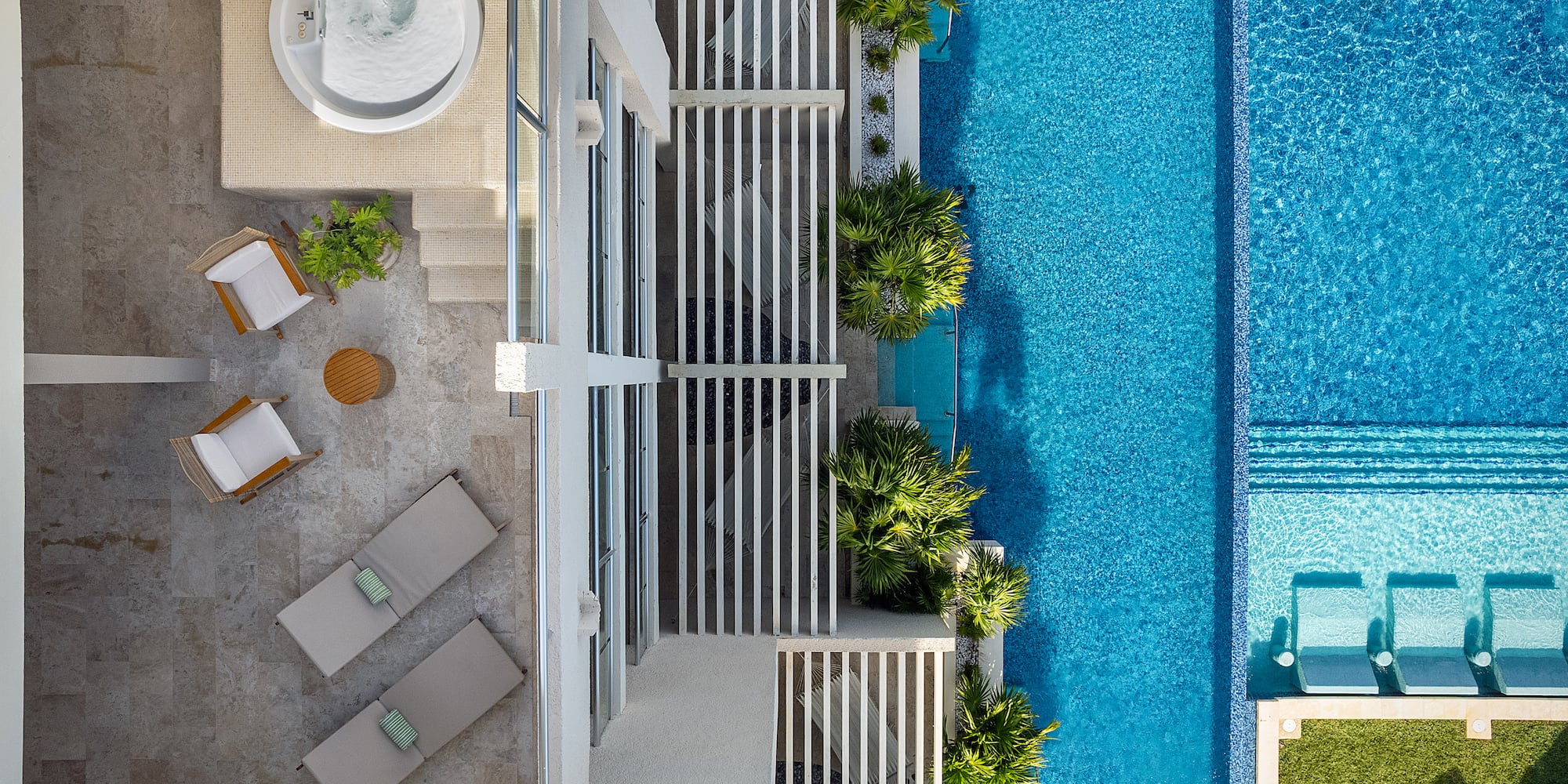 a swimming pool with a jacuzzi and a white building