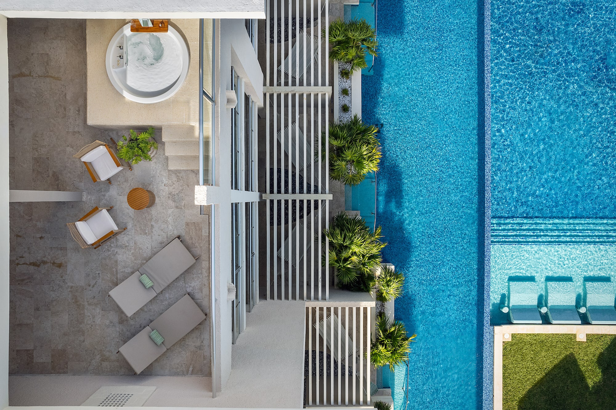 a swimming pool with a jacuzzi and a white building