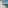 Relaxing hotel balcony with white patio furniture and panoramic ocean views.